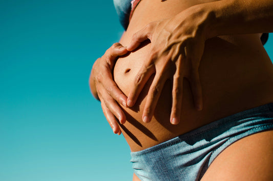 Schwangere Frau berührt ihren Bauch